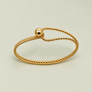 Gold twisted rope double band Orb Twist Bangle with a polished round ball closure on a soft cream background | Lemme Buy